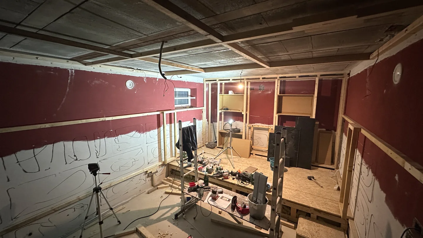 Kinoraum im Rohbau mit Holzständerwerk an Wänden und Decke sowie vorbereitetem Podest